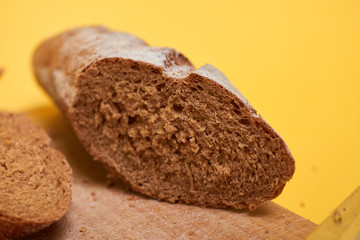 Bread on cut board. Fresh bread on the kitchen table. The healthy eating and traditional bakery concept.