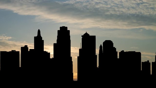 Kansas City Downtown Skyline: Time Lapse at Sunrise with Colorful Clouds and Skyscrapers in Silhouette, Missouri, USA
