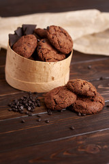 Chocolate cookies with cranberries on a wooden background