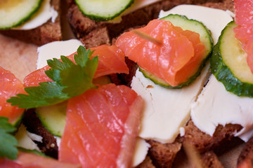 Sandwiches with red fish. Sandwiches with trout or salmon, butter and cucumber.