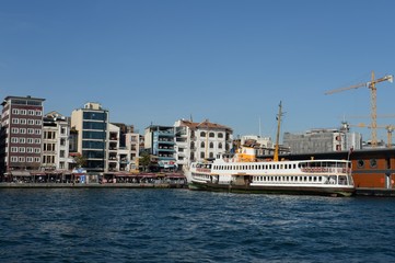 Fototapeta na wymiar Pleasure boat at the pier of the Karakay city lines in the Bosphorus. Istanbul