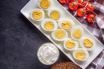 boiled chicken eggs on a dark stone background