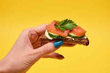 Sandwiches with red fish. Sandwiches with trout or salmon, butter and cucumber.