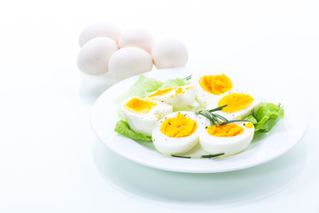 boiled eggs with salad leaves in a plate