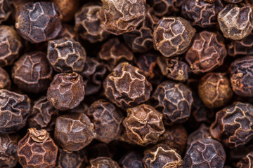 fragrant black pepper on white acrylic background