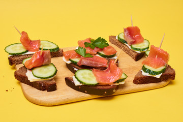 Red Trout Fish. Sandwiches with red fish. Sandwiches with trout or salmon, butter and cucumber.