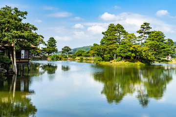 Fototapeta na wymiar View of Kasumi pond at Kenrokuen garden in sunny summer day, Kanazawa, Japan.