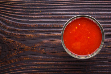 juicy canned tomatoes on wooden rustic background