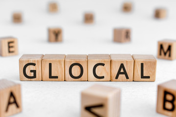 Glocal - word from wooden blocks with letters, globally available products and services glocal...