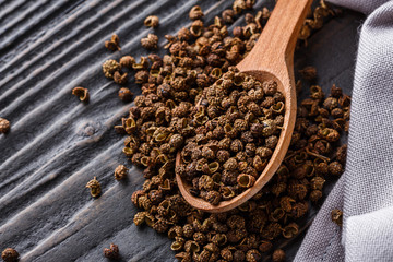 Sichuan pepper on a dark wooden rustic background