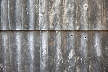 The background image of the zinc roof tile that has long been causing corrosion and deterioration which shows the beautiful colour and shadow.
