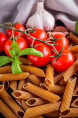 concept of traditional italian pasta with tomatoes and basil