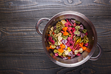 traditional italian pasta in a metal pan on a wooden background