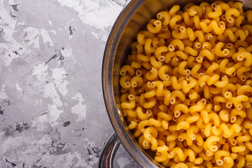 Traditional Italian pasta in a metal pan on a stone background