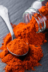 aromatic ground paprika on a dark stone background
