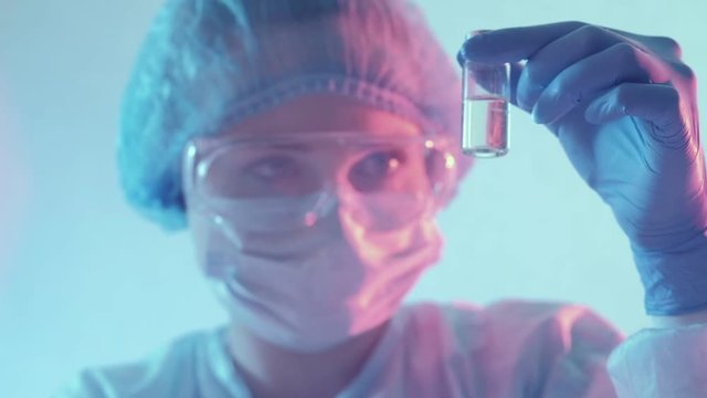 Vaccine development. Laboratory experiment. Female technician testing antigen.