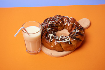 Braided roll with poppy seeds and cinnamon on yellow background. Top view
