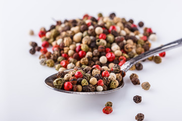 mix of peppercorns on white acrylic background