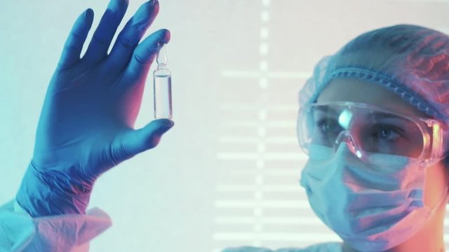 Respiratory distress. Viral vaccine. Female doctor in protective gear preparing drug for injection.