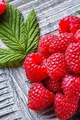 juicy fresh natural raspberries on a gray wooden rustic background