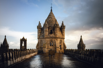 Exterior view of the cathedral of Evora (Alentejo, Portugal), dedicated to the Lady of Assumption (Nossa Senhora de Assuncao). Detail of dome and bell tower