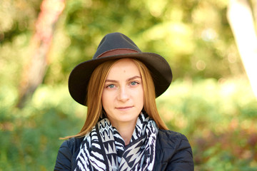 Beautiful young woman is walking in the park. Young woman enjoying nature