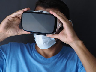 Portrait of a man in a medical mask and a virtual reality helmet.