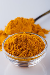 natural turmeric powder on white acrylic background