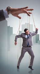 Businessman puppet being manipulated by boss