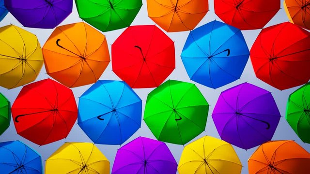 Countless colourful umbrellas hanging above the street. Looping animation. 4KHD