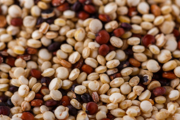 mix of quinoa grains on white acrylic background