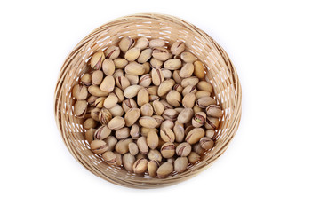 Salted pistachio nuts in wicked plate