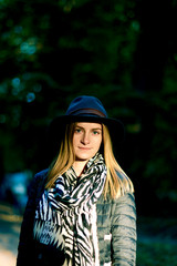 Beautiful young woman is walking in the park. Young woman enjoying nature