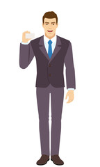 Fototapeta premium Smiling Businessman shows the business card. Full length portrait of Businessman in a flat style.