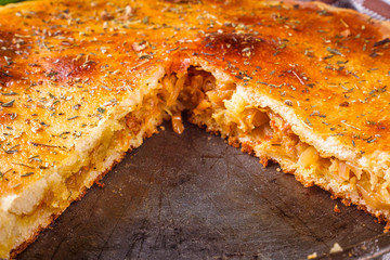 freshly baked cabbage pie on rustic wooden background