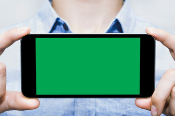 Green screen smartphones are mock up template, to be used for your best content,Business man blue shirt.