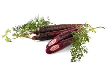 Violet carrots and halves with leaves