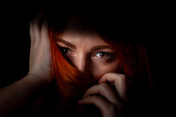 Closeup portrait of a beautiful redhead girl with long hair