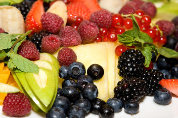 Berry and fruit mix raspberries, blueberries, apple, strawberries, pineapple, blackberries, currants, orange