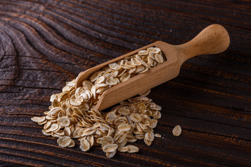 raw oatmeal on a wooden rustic background