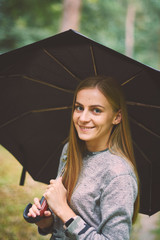 Beautiful young woman walks in the park