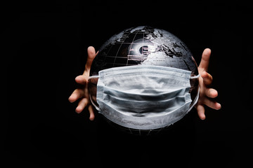 Hands of little child holding globe sphere, planet map covered with medical protective mask...