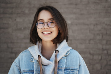 Education, career for young people concept. Close-up portrait of happy smiling 20s girl in glasses...