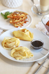 Delicious culinary dishes, desserts, ice cream, waffles and pancakes on the table in the restaurant in the style of Provence