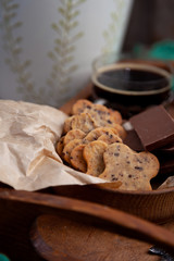 Homemade chocolate chip cookie. Baking, sweet snack. Food on a wooden table. Rustic style. Cooking at home. Chocolate for coffee.