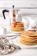 Tasty breakfast. Pancakes with strawberry confiture and butter.