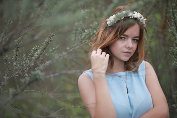Girl in blue dress in green park