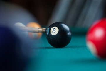 Billiards balls and cue on billiards table. Billiard sport concept
