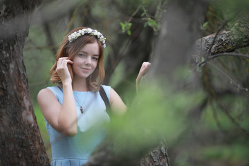 Girl in blue dress in green park