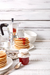 Tasty breakfast. Pancakes with strawberry confiture and butter.